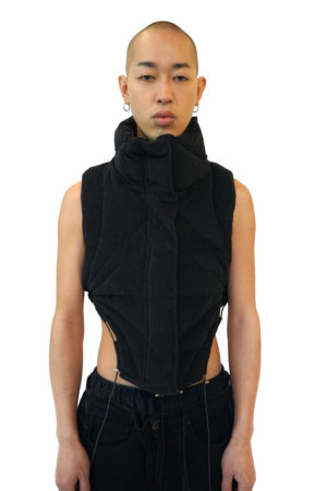 Black puffer bodyvest with organic stitching, high collar and drawstrings at the bottom.