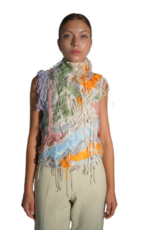 Pastel colored top with decorative yarn attached in a messy way
