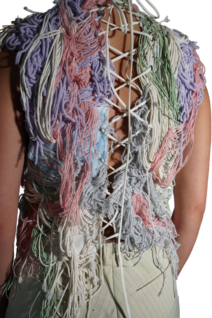 Lace closing of a top with messy yarn in a pastel hue of colors